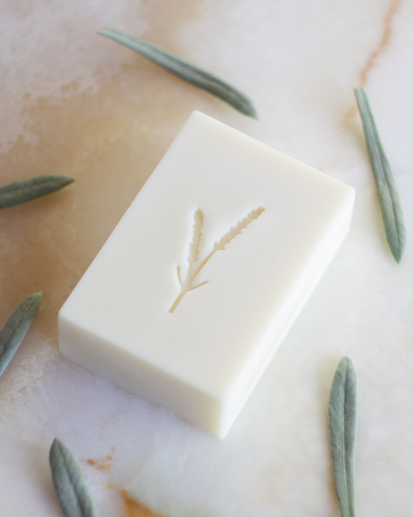 a white soap stamped with a lavender imprint