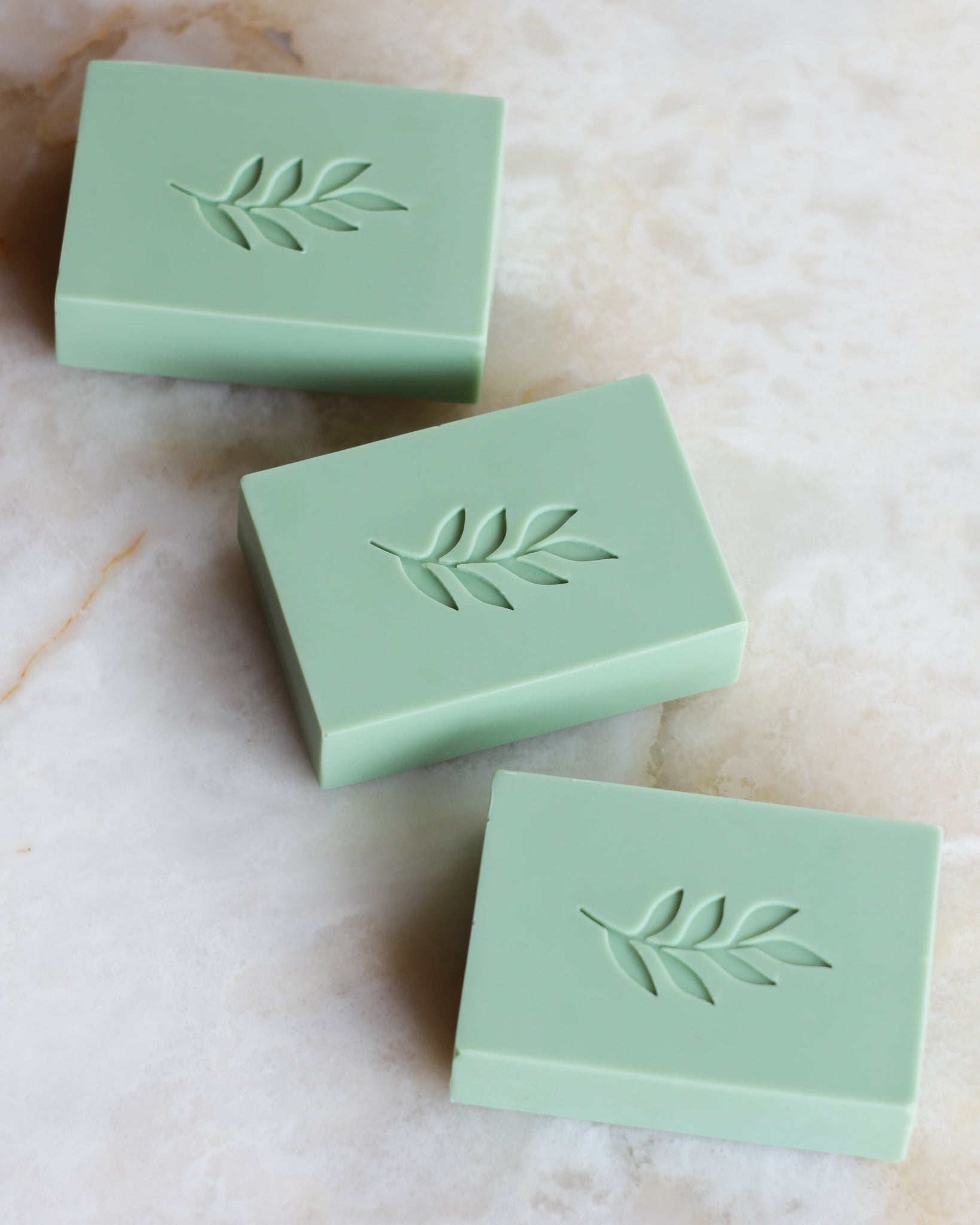 3 green soaps with leaf stamp