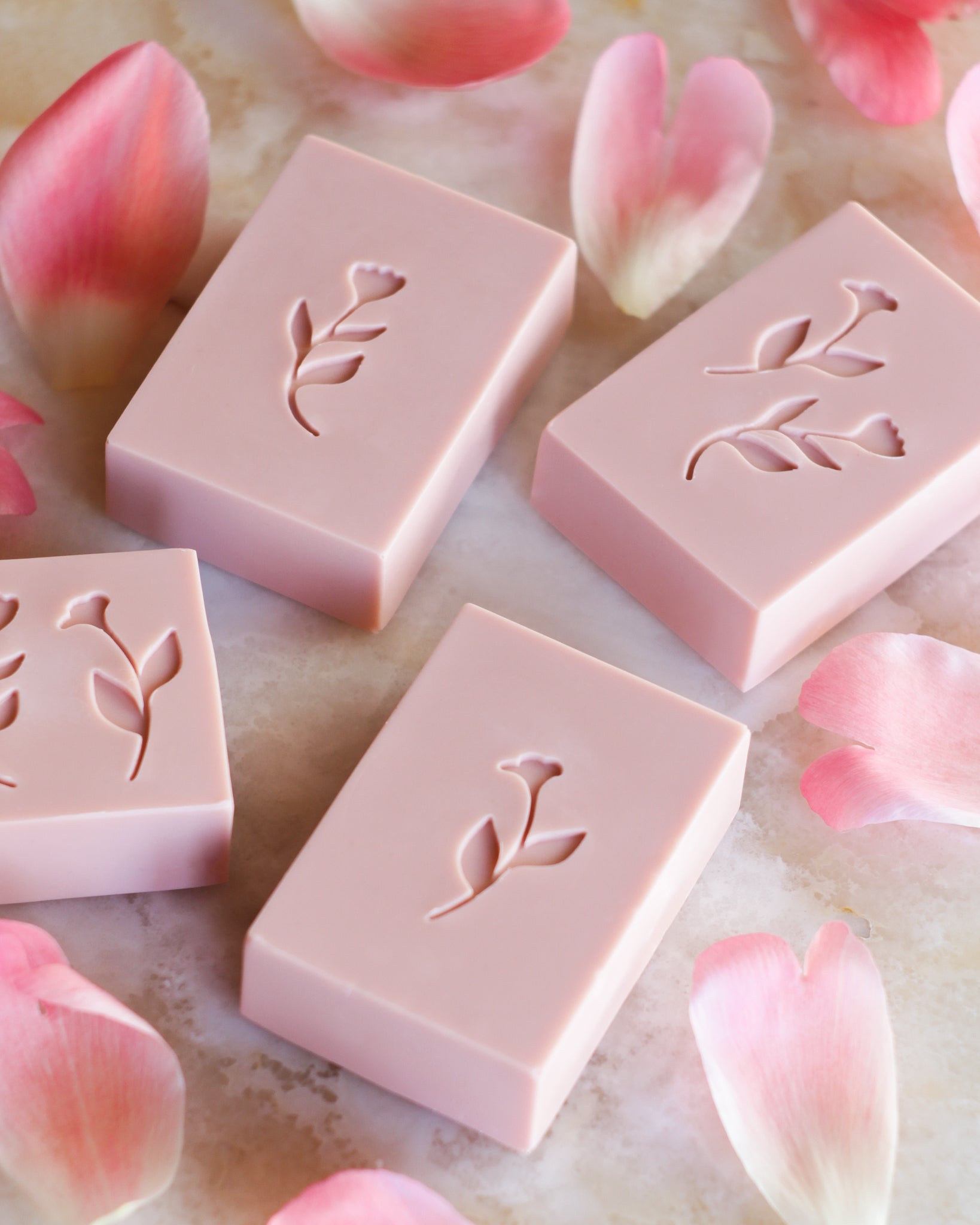 4 flower soaps and rose petals